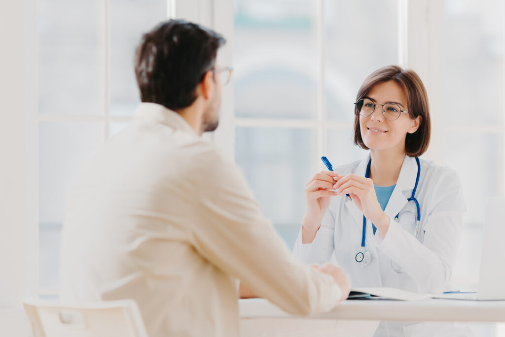 Doctor talking to a patient in his office