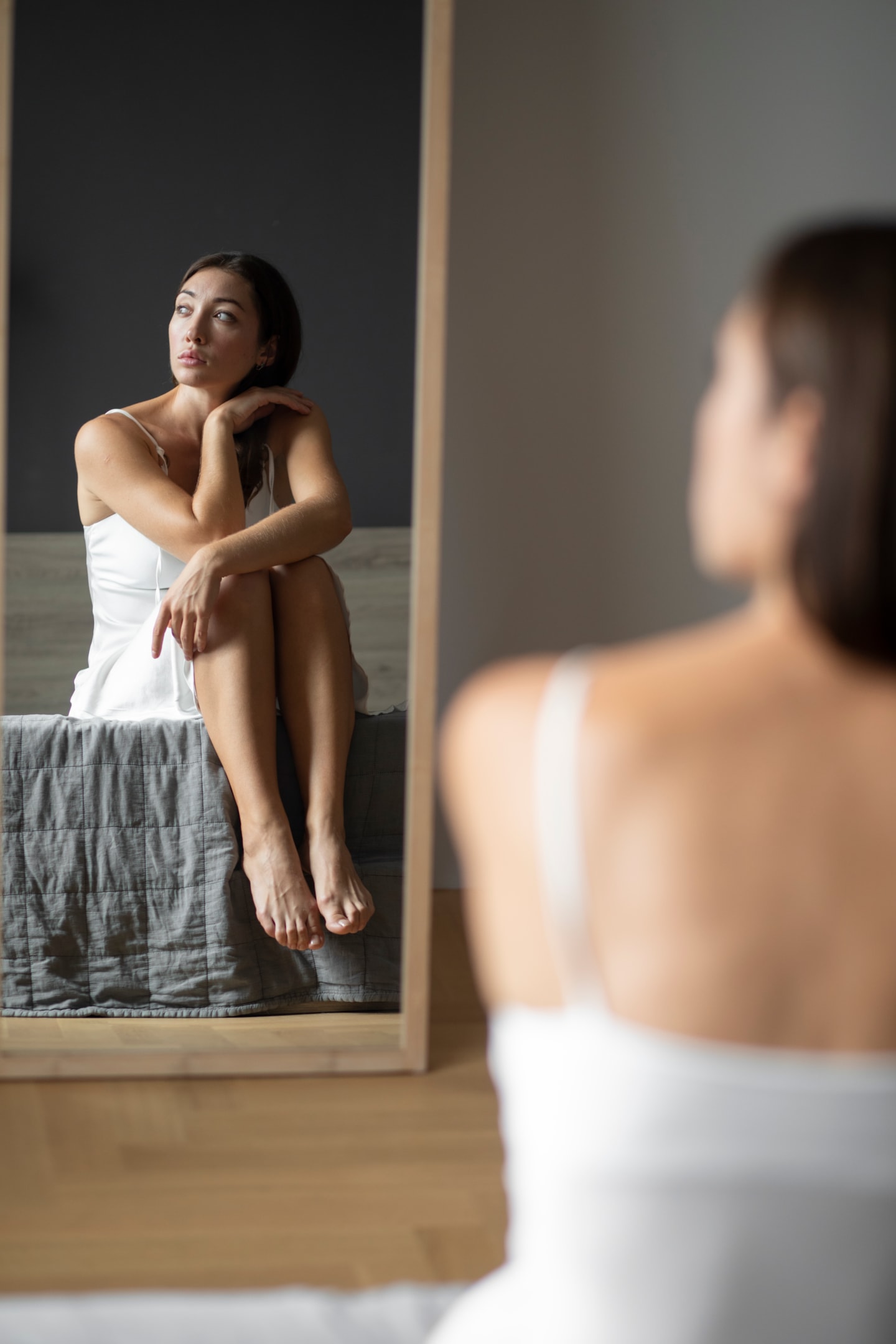 Reflection of a woman in a white dress