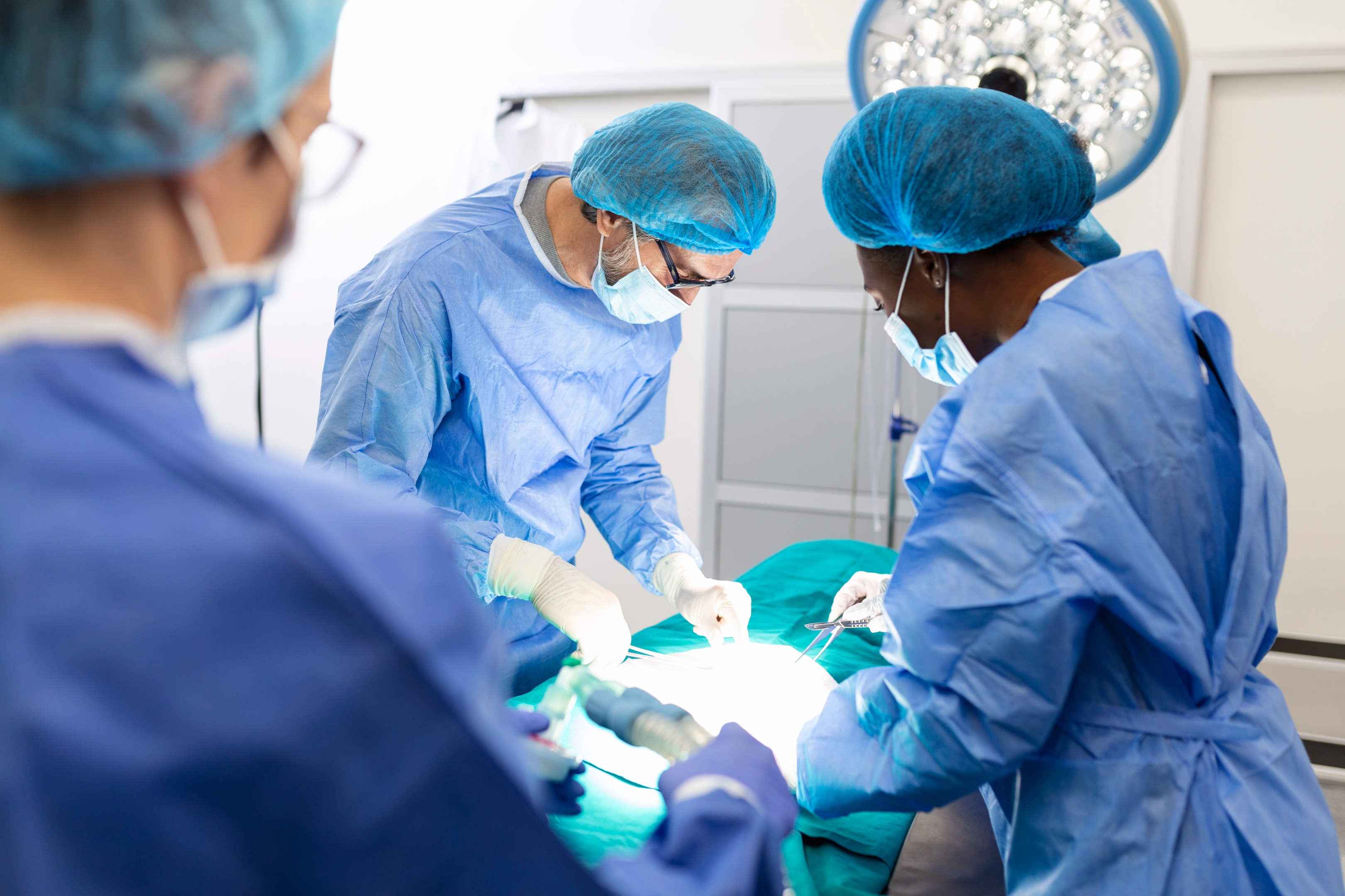 Group of surgeons performing a surgery.