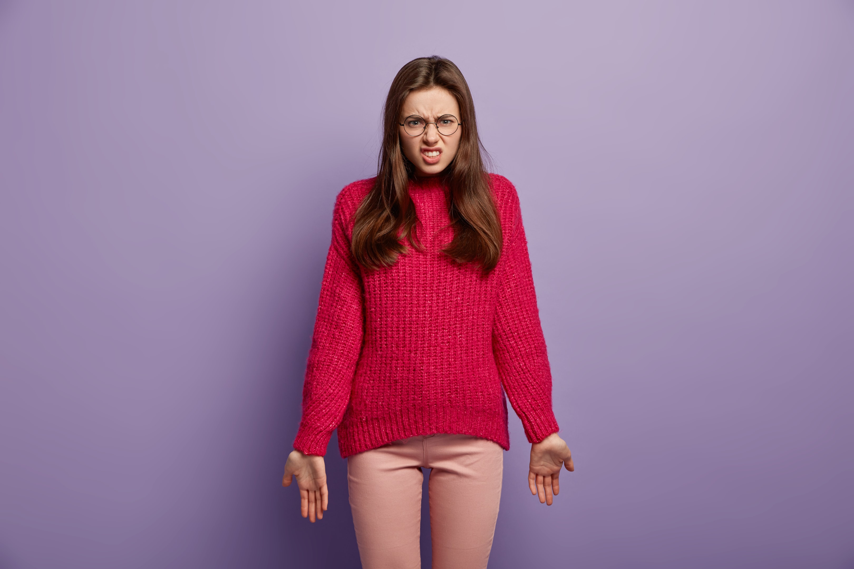 Women frustrated in a fucsia sweater